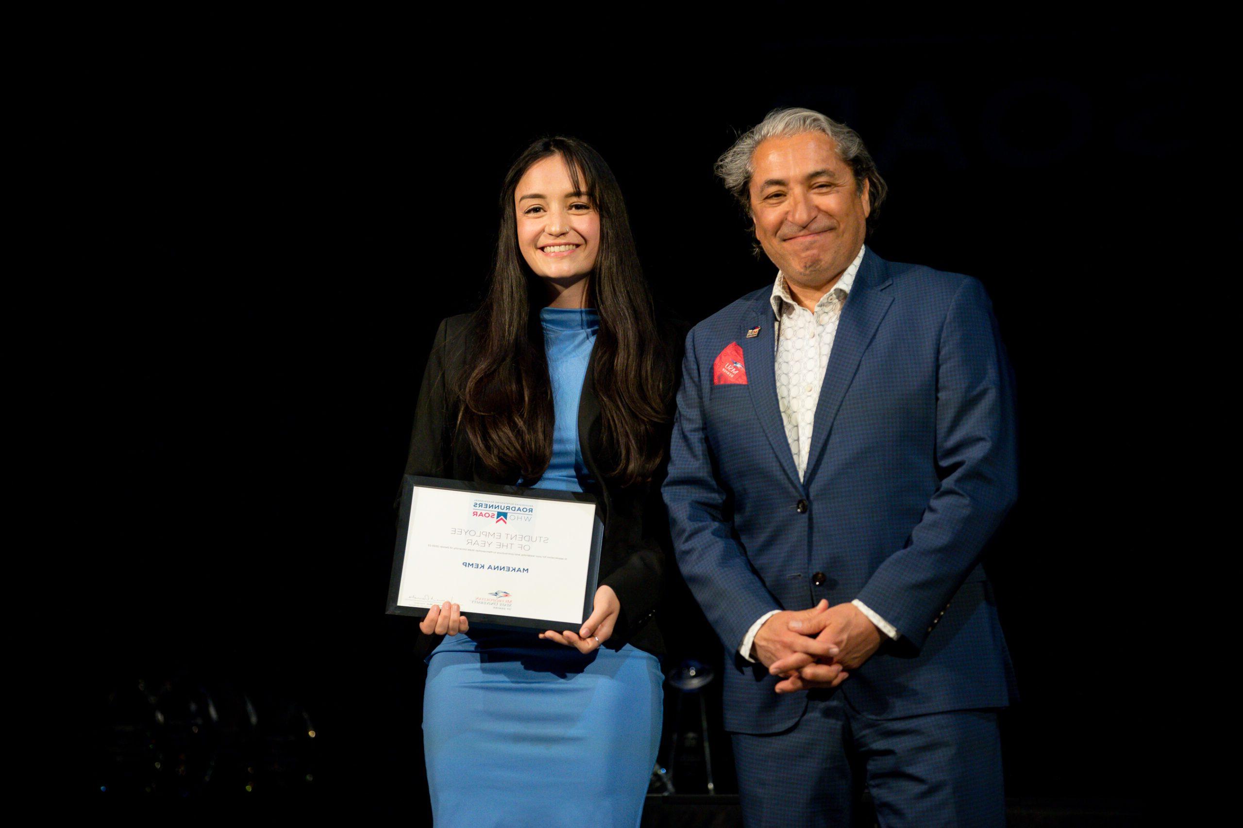 A photo of a student receiving a student employee of the year award.