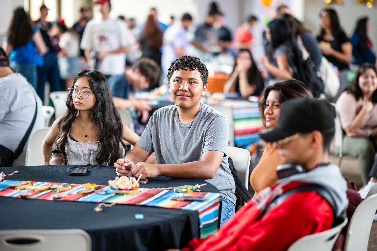 Students sitting and smiling at an event